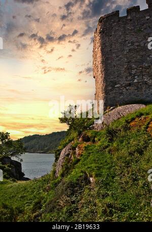 Ancient ruined Castle Tioram on the tidal island of Eilean Tioram at sunset, Loch Moidart, Lochaber, Highland, Scotland Stock Photo