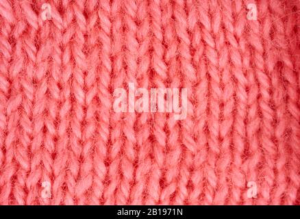 Part of pink knitted woolen clothes as a background Stock Photo