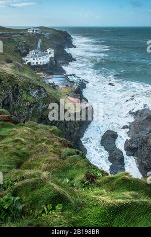 The large house known as Bakers Folly with the Lewinnick Lodge in the background on the rugged coast of Pentire Point East in Newquay in Cornwall. Stock Photo