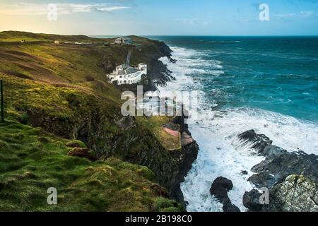 The large house Lewinnick Cove House known as Bakers Folly with the Lewinnick Lodge in the background on the rugged coast of Pentire Point East in New Stock Photo