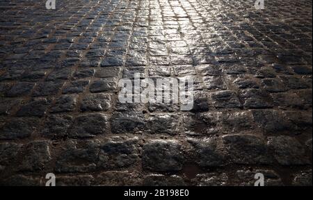Stone road after the rain close-up, at sunset Stock Photo