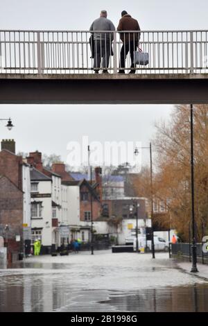 Locals look at the flooded Smithfield Road in Shrewsbury, as further flood warnings have been issued across England and Wales. Stock Photo