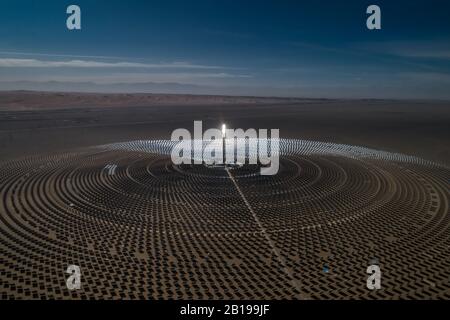 Aerial view of solar thermal plant uses mirrors that focus the sun's rays on a collection tower to produce renewable and pollution-free energy. Stock Photo