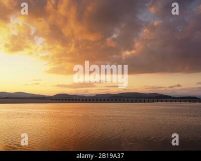 Beautiful sunset sky over the viaduct across the Kent Estuary seen from Arnside, Cumbria, England Stock Photo