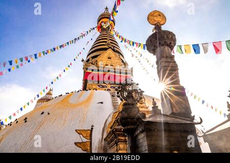 Swayambhunath Stupa, aka The Monkey Temple, during sunrise in Kathmandu, Nepal. A UNESCO Heritage Site. Ancient ruins and stone temples. Stock Photo