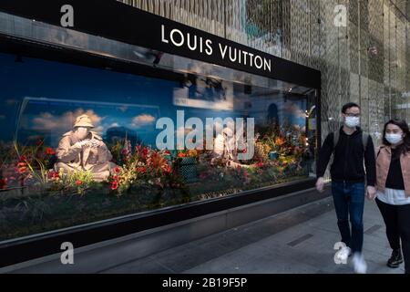 People walk past a Louis Vuitton (LV) boutique in Nanjing city, east Chinas Jiangsu province, 16 ...