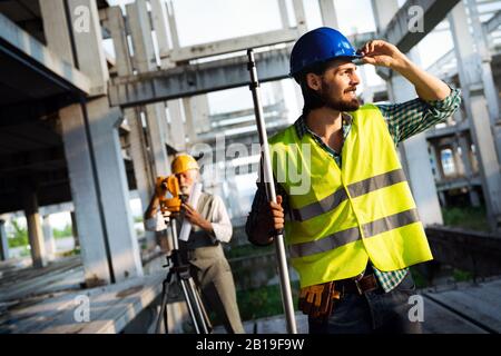 Portrait of construction architects, engineers working on building site Stock Photo