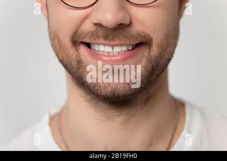 Close up cropped image wide toothy smiling young bearded man. Stock Photo