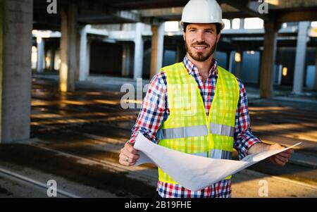 Portrait of construction architect, engineer working on building site Stock Photo