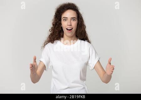 Astonished attractive millennial woman showing big size. Stock Photo