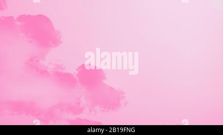 Pastel pink sky background with pink clouds. Pink watercolor abstract background, 16:9 panoramic format Stock Photo