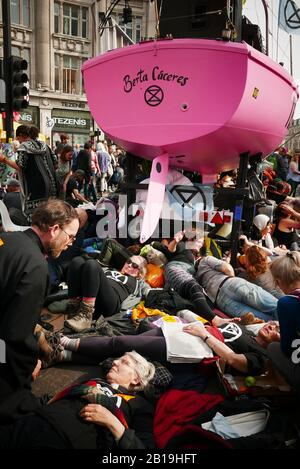 Extinction Rebellion, occupy London: Starting from Monday 15 April 2019, Extinction Rebellion organised demonstrations in London, focusing their attention on Oxford Circus, Marble Arch, Waterloo Bridge and the area around Parliament Square. Activists fixed a pink boat named after murdered Honduran environmental activist Berta Cáceres in the middle of the busy intersection of Oxford Street and Regent Street (Oxford Circus) and glued themselves to it and also set up several gazebos, potted plants and trees, a mobile stage and a skate ramp whilst also occupying Waterloo Bridge (ref:Wikipedia).