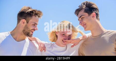 Member friendship wishes to enter into romantic relationship. Friendship love. Friendship relations. Friend zone concept. Happy together. Cheerful friends. People outdoors. Happy woman and two men. Stock Photo