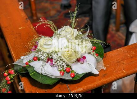 Bouquet of white roses with orchids and red berries. Orchidaceae and Roses. Stock Photo