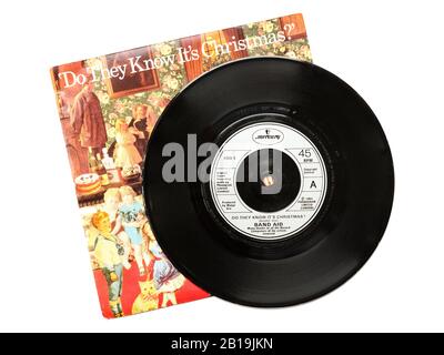 Old original Phonogram Ltd vinyl 45 RPM record Do They Know It's Christmas by Band Aid 1984 with sleeve isolated on transparent white. Geldof and Ure Stock Photo