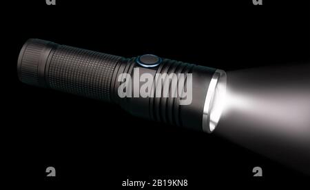 Battery powered flashlight on black background with copy space Stock Photo