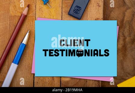 Text of client testimonials on chart paper on wooden background Stock Photo