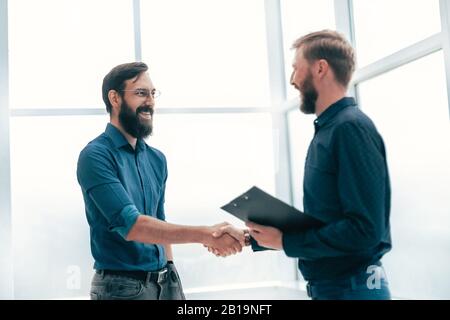 meeting and shaking hands with business people in a bright office Stock Photo