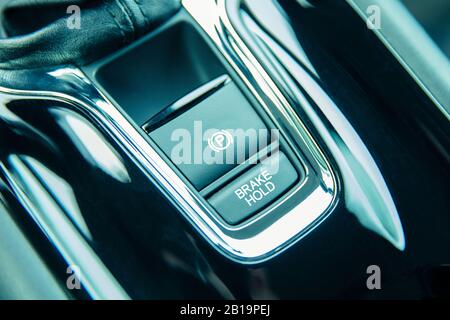 Automatic brake hold button and handbrake button in car Stock Photo