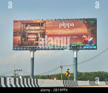 Large billboard advertising a restaurant by the ocean. Stock Photo