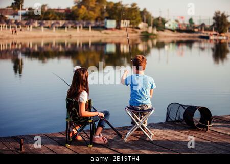Summer vacation - Sister and brother fishing at the river Stock Photo -  Alamy
