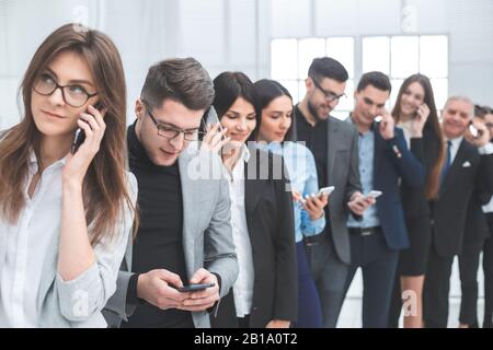 group of diverse young people use their smartphones Stock Photo