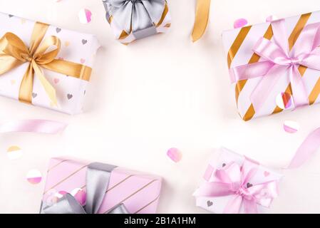Several gift boxes with bows and confetti on a white background. Stock Photo