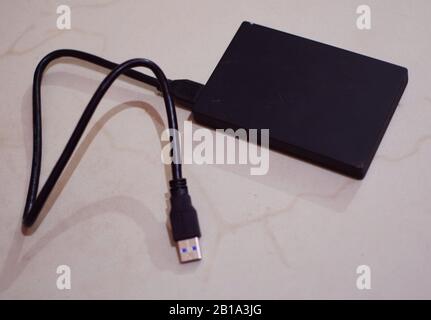 A mini grey colored external hard drive Stock Photo