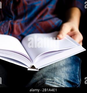 White book with clean pages in the hands of a man Stock Photo