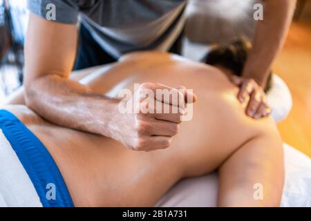 Sports massage therapy in the medical clinic. Therapeutic body massage treatment. Sports injury rehabilitation concepts. Stock Photo
