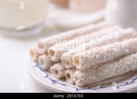 Close up of crispy coconut wafer rolls on plate Stock Photo