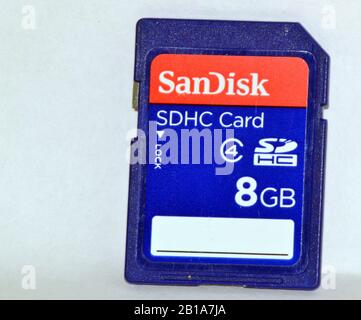 A close up of an 8 GB Sandisk branded SDHC memory card for use in cameras or computers, isolated on a white background Stock Photo