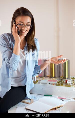young professional talented woman is happy as she has finished great successful project, she is sharing with her happiness with friend, boyfriend. clo Stock Photo