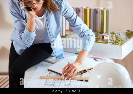 young pretty confident achitect serious holding ruler and pencil looking at the new project, close up cropped photo.woman drawing on architectural pro Stock Photo