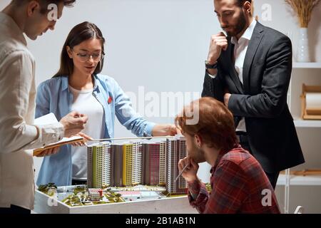 creative confident team of engineers working together in a architect studio, close up photo. architects planning, designing and overseeing the constru Stock Photo