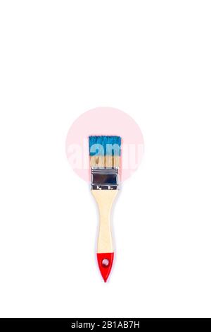 Renovation picture. Isolated white background with pink and blue paint brush located on color paper circles. Flat lay, top view, copy space. Stock Photo