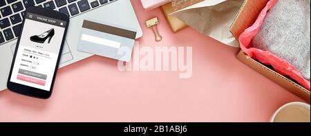 Online store for women on smart phone screen over pink copy space web banner background. Top view Stock Photo