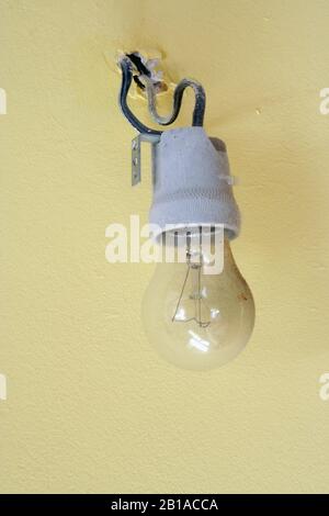 Old light bulb. Old wired light bulb. Vintage light bulb. Stock Photo
