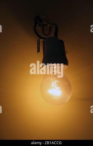 Old light bulb. Old wired light bulb. Vintage light bulb. Stock Photo