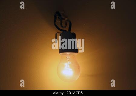 Old light bulb. Old wired light bulb. Vintage light bulb. Stock Photo
