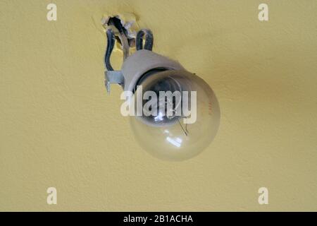 Old light bulb. Old wired light bulb. Vintage light bulb. Stock Photo