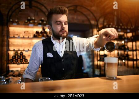 handosme bearded man is keen on making coffee, close up photo Stock Photo