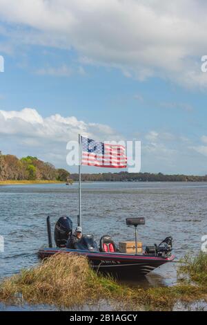 Bass Boat displaying the American Flag on the Chain of Lakes in Leesburg, Florida USA Stock Photo