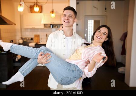 crazy awesome couple having fun, woman holding keys, close up photo, Happy couple in love with key to new home Stock Photo