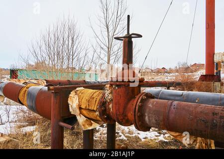 Old valve on the old heating pipe. Stock Photo