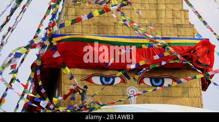 February 24, 2020, Kathmandu, Nepal: A man keeps new prayer flags at Boudhanath Stupa in celebration of Gyalpo Lhosar festival to welcome Tibetan New Year at Boudha,a UNESCO heritage site in Kathmandu,Nepal. (Credit Image: ©  Sunil Sharma/ZUMA Wire) Stock Photo