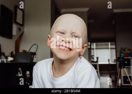 Headshot of boy smiling at camera in living room of house Stock Photo