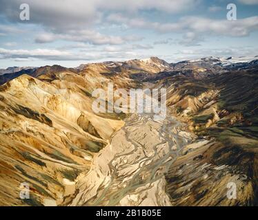 Breathtaking drone view of cloudy sky over mountain ridge and dirty brooks in Icelandic highlands Stock Photo