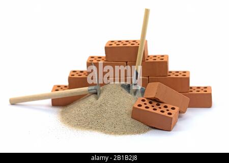 Bricks and building sand against a white background Stock Photo