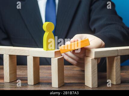 Mentor removes obstacle on a way of yellow man. Make a path to success, support, financial assistance. Career growth, professional development educati Stock Photo